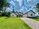 Beautiful single-story home featuring a spacious paved driveway and a lush green lawn at 4800 Hickory Oak Dr, Brooksville, FL 34601