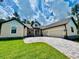 Charming single-story home with a spacious paved driveway and a manicured lawn at 4800 Hickory Oak Dr, Brooksville, FL 34601