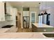 Modern kitchen featuring white cabinets, stainless steel appliances, and a stylish island with pendant lighting at 4800 Hickory Oak Dr, Brooksville, FL 34601