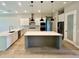 Bright kitchen with white cabinets, stainless steel appliances, and a spacious central island at 4800 Hickory Oak Dr, Brooksville, FL 34601