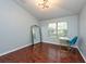 Bright bedroom features hardwood flooring, a modern light fixture, and ample sunlight at 7001 Interbay Blvd # 121, Tampa, FL 33616