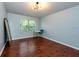 Serene bedroom with hardwood floors, desk and a sunlit window at 7001 Interbay Blvd # 121, Tampa, FL 33616