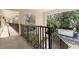 View from balcony of complex featuring railing, trees, and nice greenery at 840 Virginia St # 301, Dunedin, FL 34698