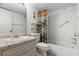 Bright bathroom with white tiled shower and marble counter, creating a clean, relaxing atmosphere at 840 Virginia St # 301, Dunedin, FL 34698