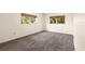The bedroom has neutral carpet and two windows for natural light at 840 Virginia St # 301, Dunedin, FL 34698