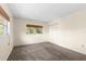 Bright bedroom with plush carpet, window, and a closet for ample storage at 840 Virginia St # 301, Dunedin, FL 34698