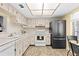 Kitchen features white cabinets, modern appliances, and recessed lighting at 840 Virginia St # 301, Dunedin, FL 34698