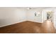 This is a bright living room with hardwood floors and a ceiling fan at 840 Virginia St # 301, Dunedin, FL 34698
