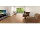 Bright living room featuring laminate wood flooring and neutral wall paint at 840 Virginia St # 301, Dunedin, FL 34698