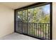 Screened porch with beautiful views of lush trees and landscaping at 840 Virginia St # 301, Dunedin, FL 34698