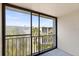 Balcony view offering natural light and serene views of the surrounding trees and neighborhood at 840 Virginia St # 301, Dunedin, FL 34698