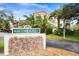Community signage displaying the building number and street address in front of condo building at 840 Virginia St # 301, Dunedin, FL 34698