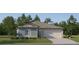 Charming one-story home featuring a covered entry, two-car garage, and well-manicured lawn at 8548 Bella Mar Trl, Parrish, FL 34219