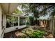 A backyard with healthy lawn is surrounded by a privacy fence and shaded by beautiful mature trees at 878 Franklin Cir, Palm Harbor, FL 34683
