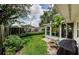 Private backyard featuring a lush lawn, mature trees, and a serene outdoor space perfect for relaxation at 878 Franklin Cir, Palm Harbor, FL 34683