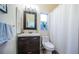 Well-lit bathroom showcasing a modern vanity, framed mirror, and a clean, functional layout at 878 Franklin Cir, Palm Harbor, FL 34683