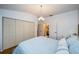 A cozy bedroom with wood floors, a closet, and an open doorway to an ensuite bathroom at 878 Franklin Cir, Palm Harbor, FL 34683