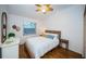 Cozy bedroom with a comfortable bed, bright window, dresser, and stylish decor at 878 Franklin Cir, Palm Harbor, FL 34683