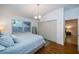 Bright bedroom features wood floors, a large closet and a window with blinds at 878 Franklin Cir, Palm Harbor, FL 34683