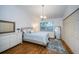 A serene bedroom featuring a plush queen bed, hardwood floors, and a built-in closet at 878 Franklin Cir, Palm Harbor, FL 34683