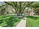 Scenic community park featuring lush green space, mature trees, benches, and a convenient walkway at 878 Franklin Cir, Palm Harbor, FL 34683