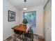 Cozy dining area with a wooden table, modern stools, and a window providing natural light at 878 Franklin Cir, Palm Harbor, FL 34683