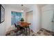 Bright dining area featuring a rustic wood table, modern stools, and ample natural light at 878 Franklin Cir, Palm Harbor, FL 34683