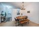Modern dining area with a wooden table, bench seating, and a view into the entry hall and living room at 878 Franklin Cir, Palm Harbor, FL 34683