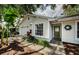 Charming single-story home featuring a garage, neutral color scheme and lush landscaping with tropical accents at 878 Franklin Cir, Palm Harbor, FL 34683