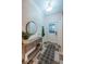 Inviting foyer with decorative rug, tiled floor, coat rack, console table with decor, and front door with glass panel at 878 Franklin Cir, Palm Harbor, FL 34683