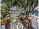 A well-maintained home with a tidy yard is shaded by mature trees and has a clean driveway at 878 Franklin Cir, Palm Harbor, FL 34683