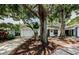 Charming single-story home with a well-maintained lawn, a two-car garage, and mature trees at 878 Franklin Cir, Palm Harbor, FL 34683