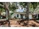 Home exterior with big trees, garden and lights during the day at 878 Franklin Cir, Palm Harbor, FL 34683