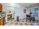 Tile floor leading to the kitchen and entryway with an eating area for four and a view to the hall at 878 Franklin Cir, Palm Harbor, FL 34683