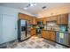 Kitchen area with stainless steel appliances, wooden cabinets and tiled countertops, all freshly cleaned at 878 Franklin Cir, Palm Harbor, FL 34683