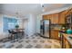 Open concept kitchen with modern appliances, tile floors and dining area with a large window at 878 Franklin Cir, Palm Harbor, FL 34683