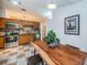 View of the kitchen with stainless steel appliances and wooden cabinets, plus a dining table for two at 878 Franklin Cir, Palm Harbor, FL 34683
