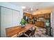View of the kitchen with stainless steel appliances and wooden cabinets, plus a dining table for two at 878 Franklin Cir, Palm Harbor, FL 34683