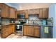 Kitchen featuring warm wood cabinetry, stainless steel appliances, and granite countertops at 878 Franklin Cir, Palm Harbor, FL 34683