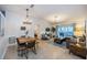 Open living space with dining area, comfy sofa, and sliding door to the patio, creating a seamless indoor-outdoor flow at 878 Franklin Cir, Palm Harbor, FL 34683