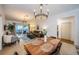 Open-concept living and dining area featuring a wooden dining table, a comfortable sofa, and sliding doors to the patio at 878 Franklin Cir, Palm Harbor, FL 34683