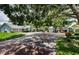 Neighborhood entrance and view with green lawn and mature trees at 878 Franklin Cir, Palm Harbor, FL 34683