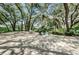 A community pool area includes lounge chairs, tables and mature trees for a shady spot to relax at 878 Franklin Cir, Palm Harbor, FL 34683