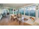 Bright and airy sunroom with wicker furniture, a ceiling fan, and lots of light at 878 Franklin Cir, Palm Harbor, FL 34683