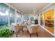 Inviting sunroom with wicker furniture, light-filled windows, and seamless access to the outdoors at 878 Franklin Cir, Palm Harbor, FL 34683