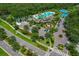 Aerial view of community amenities including a pool, tennis courts, playground, parking and manicured green space at 20115 Nob Oak Ave, Tampa, FL 33647