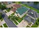 An aerial view of a residential neighborhood featuring green lawns, mature trees, and houses with attached garages at 20115 Nob Oak Ave, Tampa, FL 33647