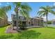 This home features a screened in pool and patio and a well-maintained lawn at 20115 Nob Oak Ave, Tampa, FL 33647