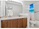 Bright bathroom with double vanity, ample counter space, and blue beach themed shower curtain at 20115 Nob Oak Ave, Tampa, FL 33647