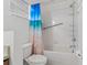 Bathroom featuring a blue beach-themed shower curtain, toilet, and accessibility bars at 20115 Nob Oak Ave, Tampa, FL 33647